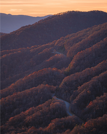 A colorful sunset over a craggy  mountain peak in the Blue Ridge Mountains of North Carolina
