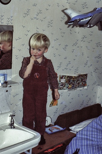 Toddler boy brushing his teeth, back in the 1970's