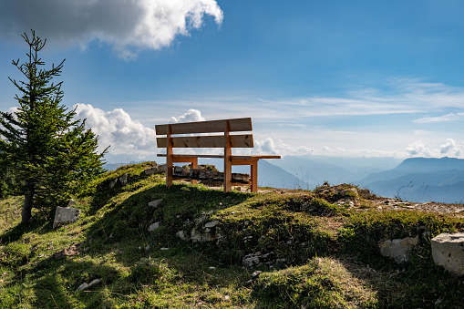 Bench on a mountain with a beautiful view over the mountains in the valley.