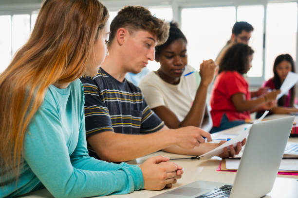 istock Teenager students learning together at High School Classroom, doing exercise 1491790460