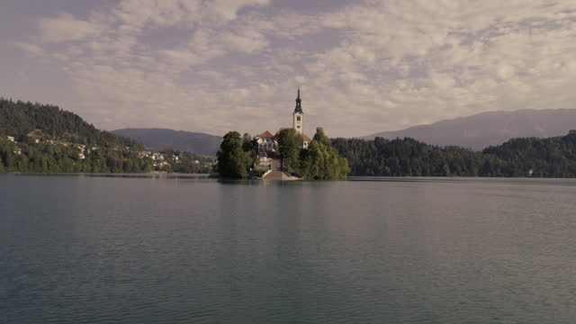 Flight around Church of Assumption on island on Lake Bled, Slowenia