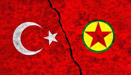 Turkey and PKK painted flags on wall with crack. Turkey vs PKK