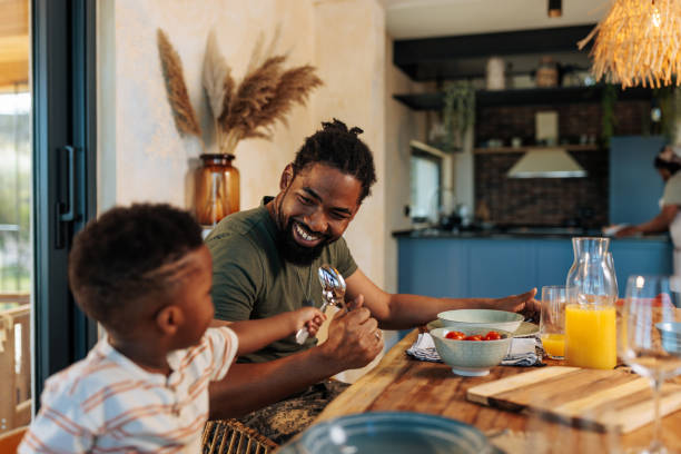 istock Father and song having fun at lunch table. 1491795674