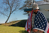 War veteran in uniform with American flag.