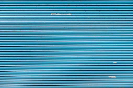 detail of a worn blue metal shutter