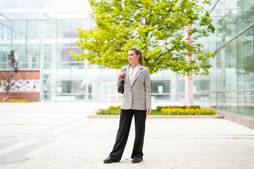 beautiful businesswoman standing in the garden of the business center