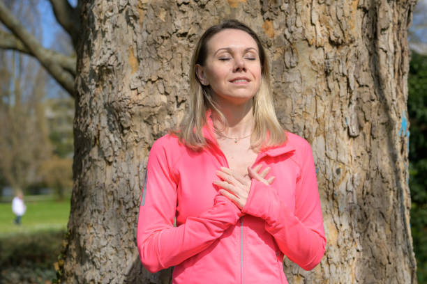 istock Blonde woman relaxing in front of a tree 1491802124