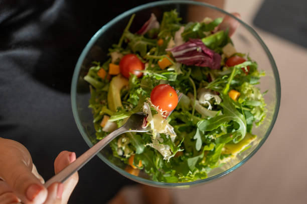 istock a person eating a full salad 1491810756