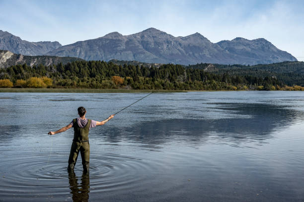 Young man practices sport fly fishing in the Rio Grande or Futaleufú, in Chubut, Patagonia Argentina.