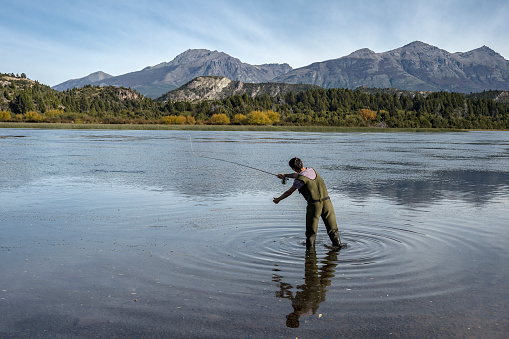 Young man practices sport fly fishing in the Rio Grande or Futaleufú, in Chubut, Patagonia Argentina.
