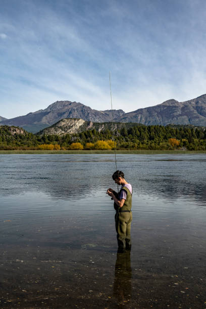 istock Young man practices sport fly fishing 1491811681
