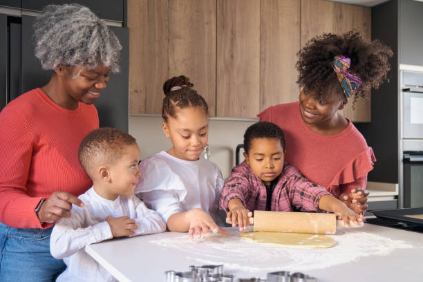 istock African happy family roll cookie dough out with a rolling pin in the kitchen. 1491817706