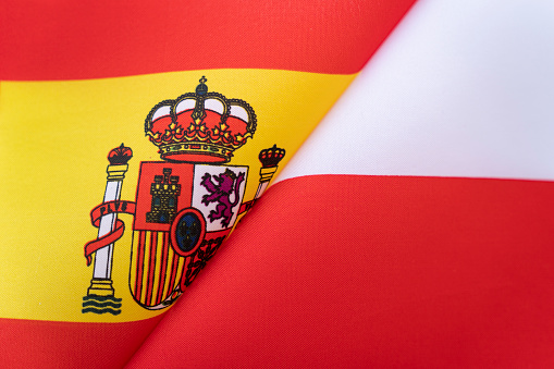 Flags Spain and Poland. The concept of international relations between countries. The state of governments. Friendship of peoples.