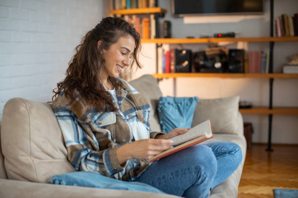 istock Woman relaxing and reading a book 1491822147