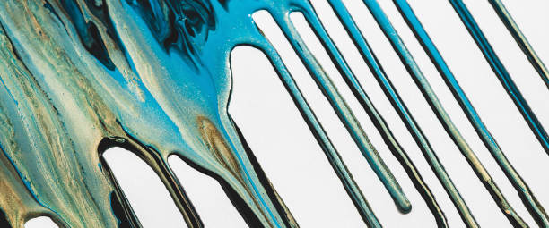 istock Liquid ink flows down white canvas. Fluid art background with mix of light blue and golden tints. Acrylic paints flows to down. Cyan gold abstract backdrop. Mixing of glitter colors. Aqua with gilding 1491822156