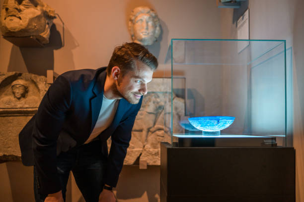 istock Man in a Blue Suit and a Blue Glass Bowl 1491823748