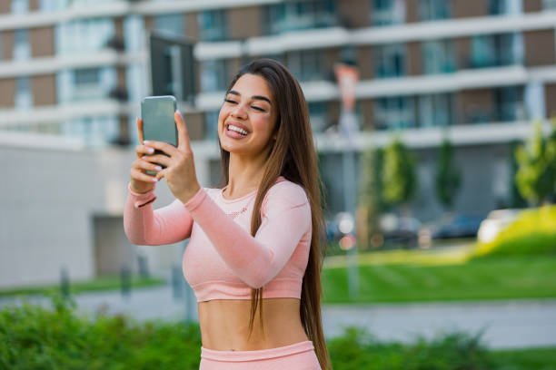 istock Beautiful fit young woman taking a selfie outdoors before her workout 1491829617
