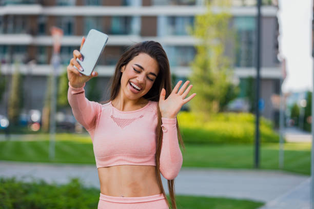 istock Beautiful fit young woman taking a selfie outdoors before her workout 1491829628