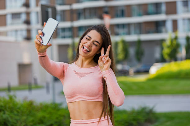 istock Beautiful fit young woman taking a selfie outdoors before her workout 1491829631