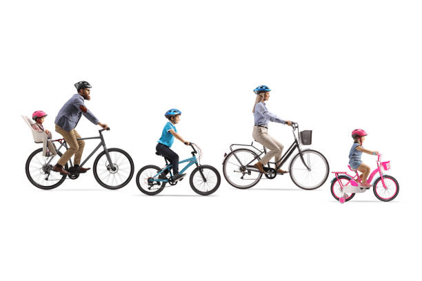 Family with three children riding bicycles stock photo