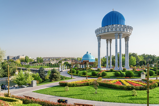 Awesome view of scenic rotunda at the Memorial Shakhidlar Hotirasi complex in Tashkent, Uzbekistan. Blue domes of Museum of Victims of Political Repression are visible at left side.