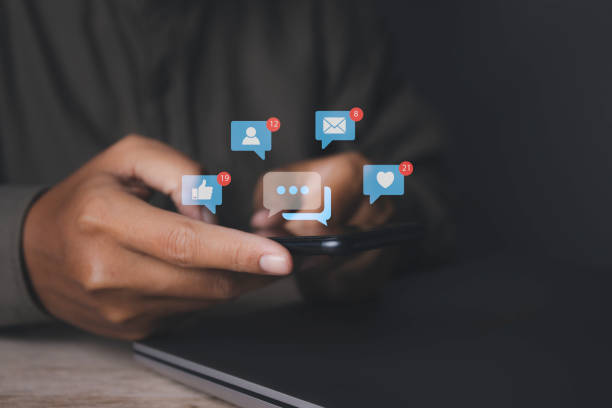 istock man using smartphone with social media to interactions icon on internet post. 1491851000
