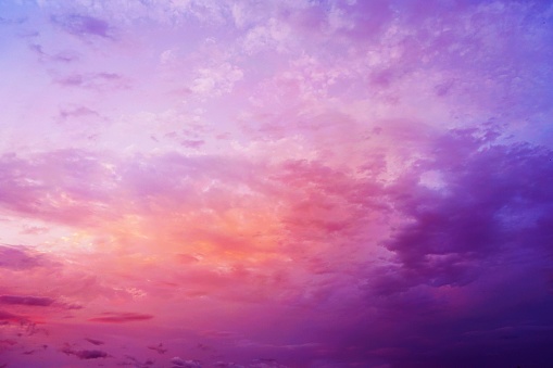 Evening sky with clouds. Sunset. Blue purple orange magenta red pink coral violet lilac yellow golden sky background for design. Colorful skies. Summer. Dawn. Magical, fantasy, romance.