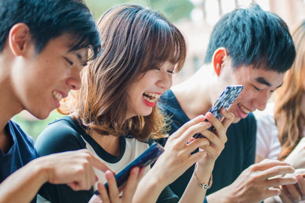 istock In the lounge area outside the classroom corridors,  college students gather after class, engrossed in their smartphones. One of the girls, with a contented smile, looks at the content on her phone and bursts into laughter. 1491852069
