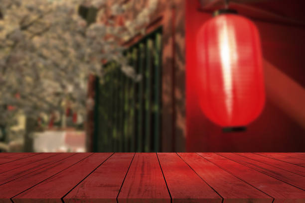 istock top desk with red lamp blur background,wooden table 1491856539