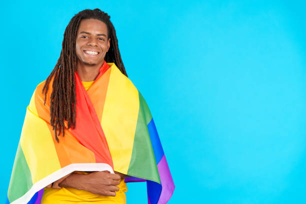 istock Happy latin man with dreadlocks wrapped with a lgbt flag 1491856912