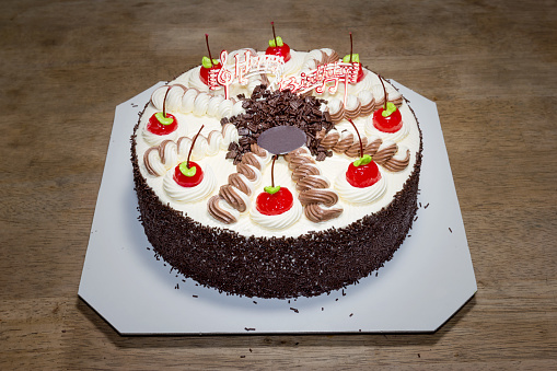 Birthday Cake with Cream and red cherry