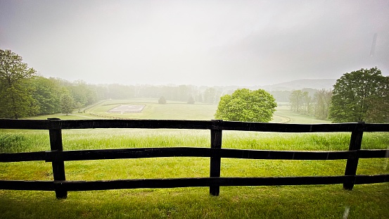 Green Meadow with Fence on a Rainy Day