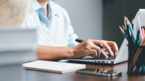 istock Education concept. Close up of female student make notes hand typing in laptop study online on computer from home. Woman typing in computer talking distant on webcam virtual zoom call on laptop. 1491861107