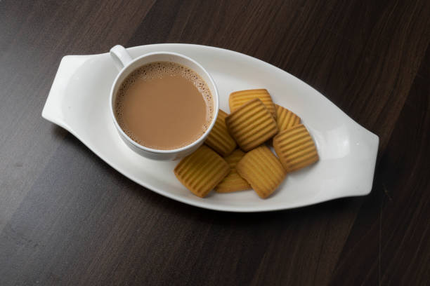 istock Cup of tea with egg and milk cookies isolated on textured background 1491861220