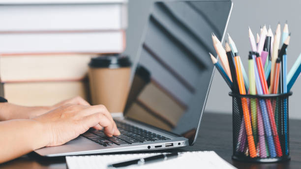 istock Education concept. Close up of female student make notes hand typing in laptop study online on computer from home. Woman typing in computer talking distant on webcam virtual zoom call on laptop. 1491861842