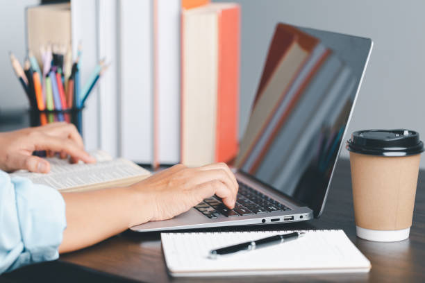istock Education concept. Close up of female student make notes hand typing in laptop study online on computer from home. Woman typing in computer talking distant on webcam virtual zoom call on laptop. 1491862703