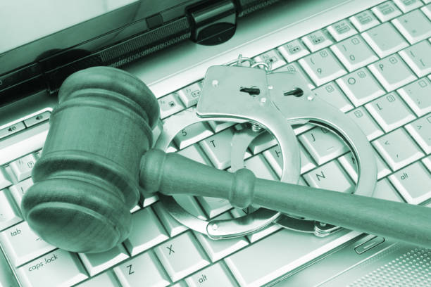 istock Judge gavel and steel handcuffs on laptop computer keyboard. 1491867409