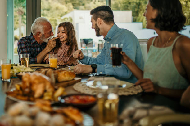 istock Two Families Enjoying Meal At Home Together 1491872022