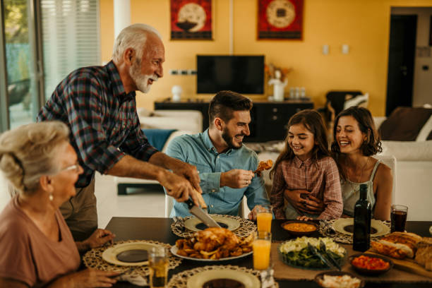 istock Multi Generation Family Enjoying Meal Around Table At Home Together 1491873638