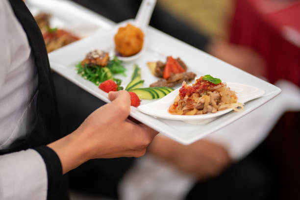 istock A close-up shot captures a waitress walking in a restaurant while carrying dishes. 1491873665