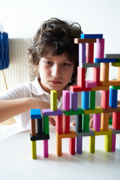 istock Cute Little Boy Playing with wooden block 1491876326