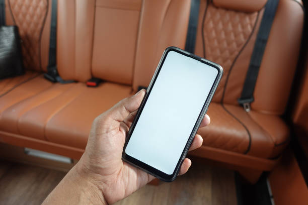 istock hand holding smart phone with empty screen in a car 1491878951
