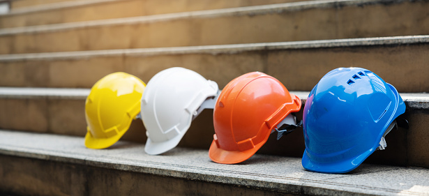 Helmets for construction workers, engineers, technicians, inspectors who work on construction sites. Safety hardhat while working to prevent accidents. work equipment of Blue collar - stock photo