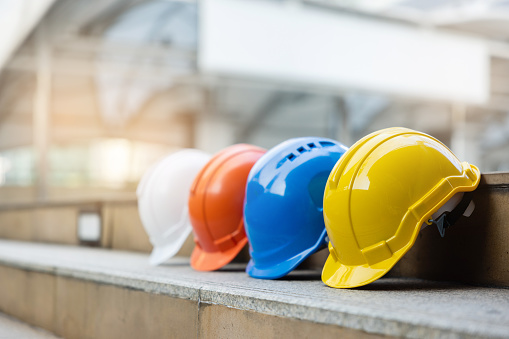 Helmets for construction workers, engineers, technicians, inspectors who work on construction sites. Safety hardhat while working to prevent accidents. work equipment of Blue collar - stock photo