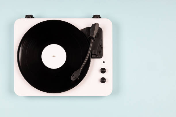istock Vinyl turntable with vinyl plate on a blue background. Modern gramophone record player. Retro sound technology to play music 1491883464
