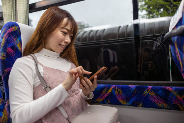 istock Woman using smartphone in airport shuttle 1491887306