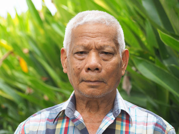 istock Senior man looking at the camera with a smile while standing outdoors. 1491890969