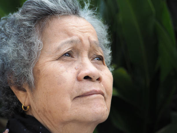 istock An elderly Asian woman looking up while standing outdoors 1491890975