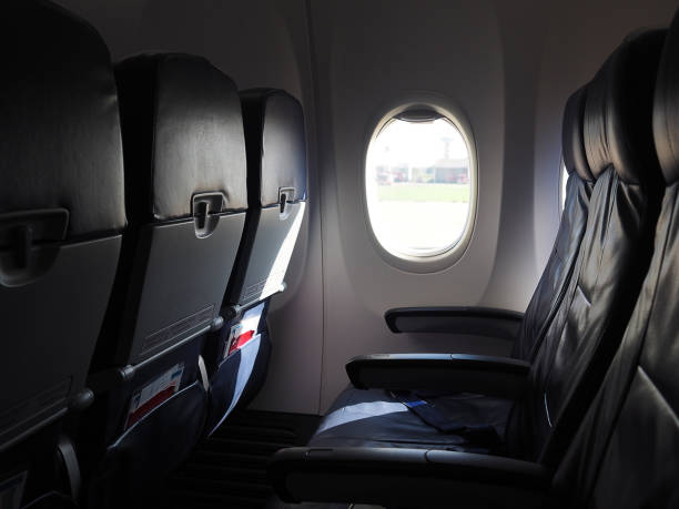 istock Airplane seats and windows inside an aircraft 1491891405