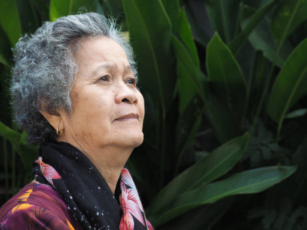 istock An elderly Asian woman looking up while standing outdoors 1491892373